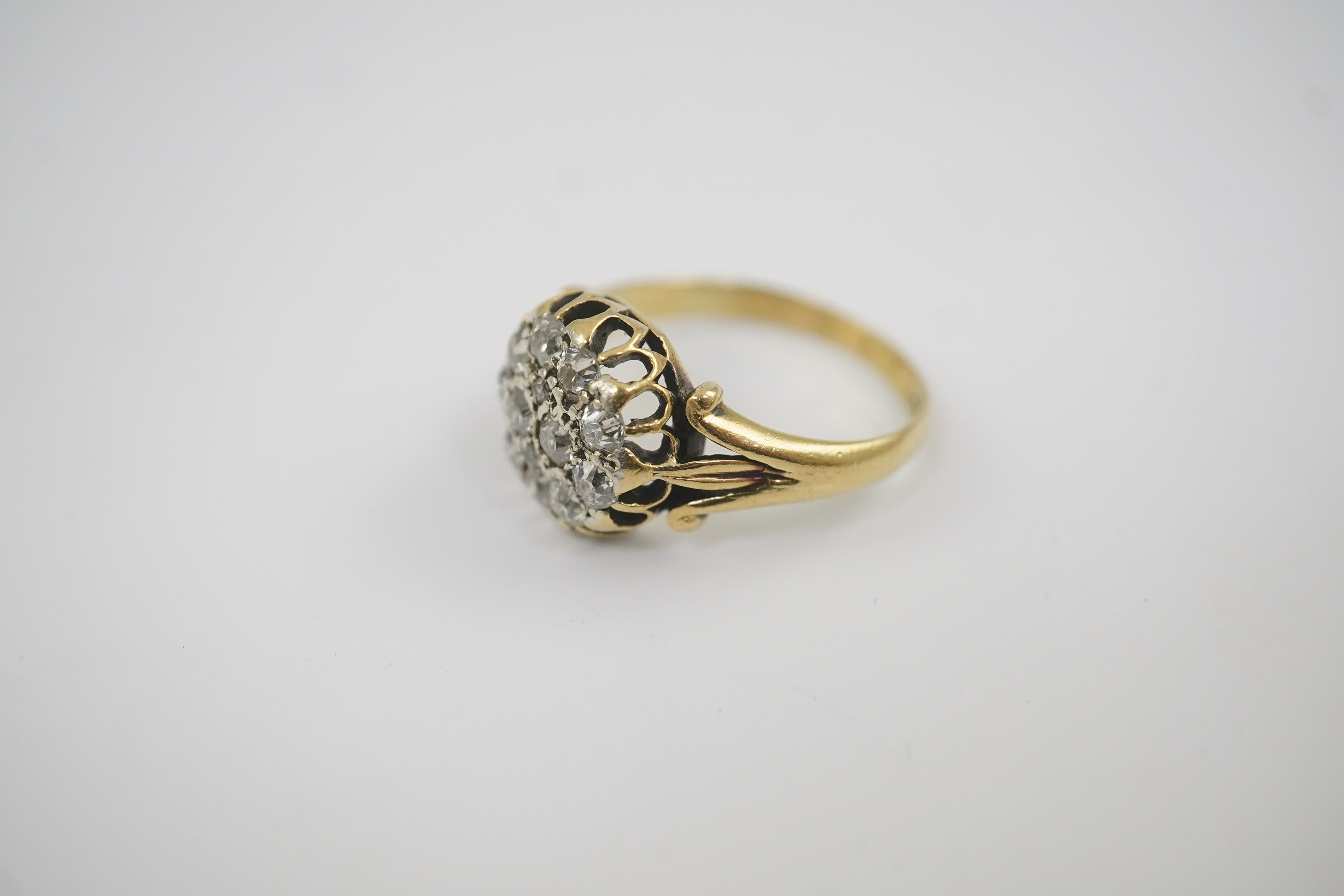 An early to mid 20th century gold and diamond set circular cluster ring